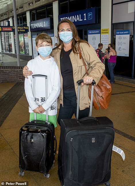 Amanda Thompson with her son Finley flew into Manchester Airport today from Spain. Ms Thompson, who lives In Barcelona, said: 