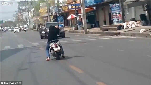 Shocking: The moped rider begins to veer towards oncoming traffic before suddenly straightening up again
