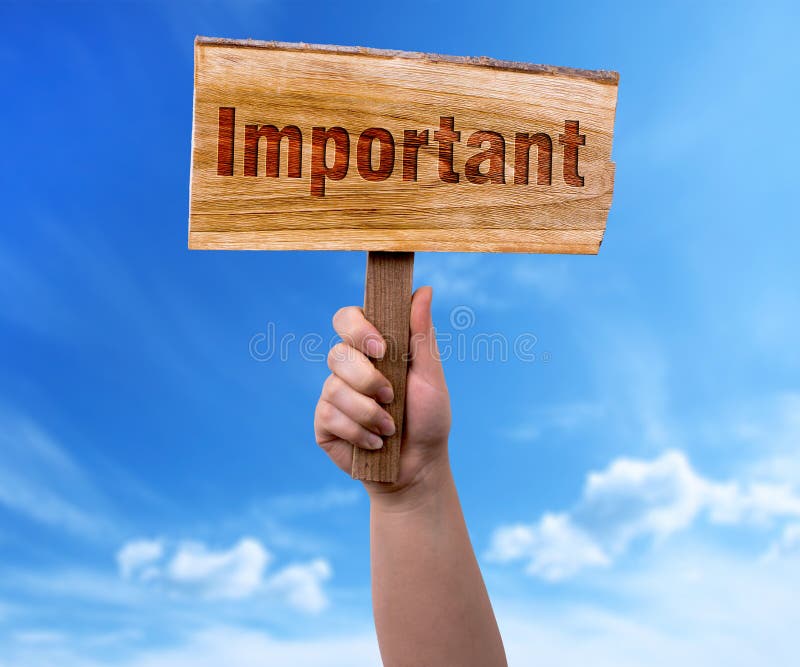 Important wooden sign. A woman holding important wooden sign on blue sky background royalty free stock photo