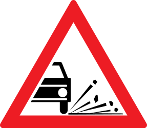 Traffic sign of Romania: Warning for loose chippings on the road surface