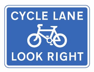 Pedestrians look right for cyclists road sign